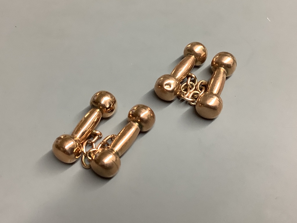 A pair of yellow metal overlaid dumbbell cufflinks